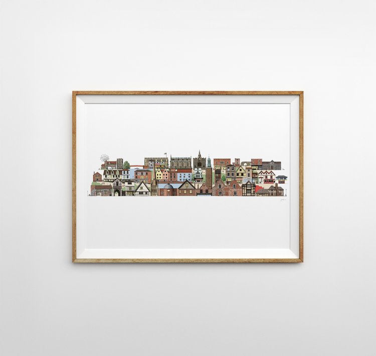 Illustrated print of iconic famous Norwich architecture in various colours in a linear line on a white background. The print is framed horizontally with a thin light wooden frame on a light grey background