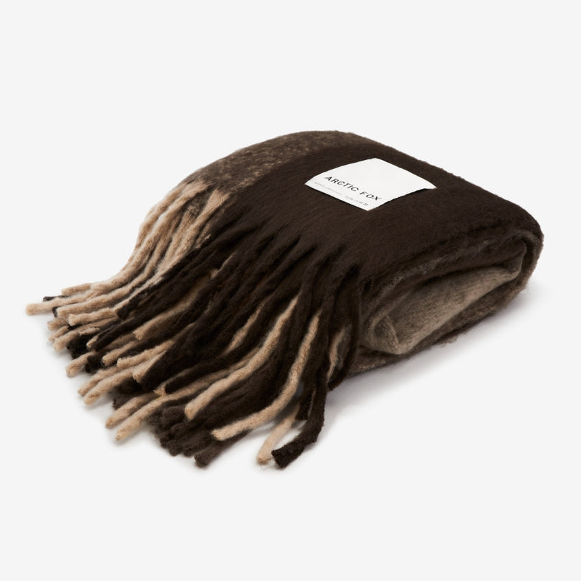 A brown throw on a white background