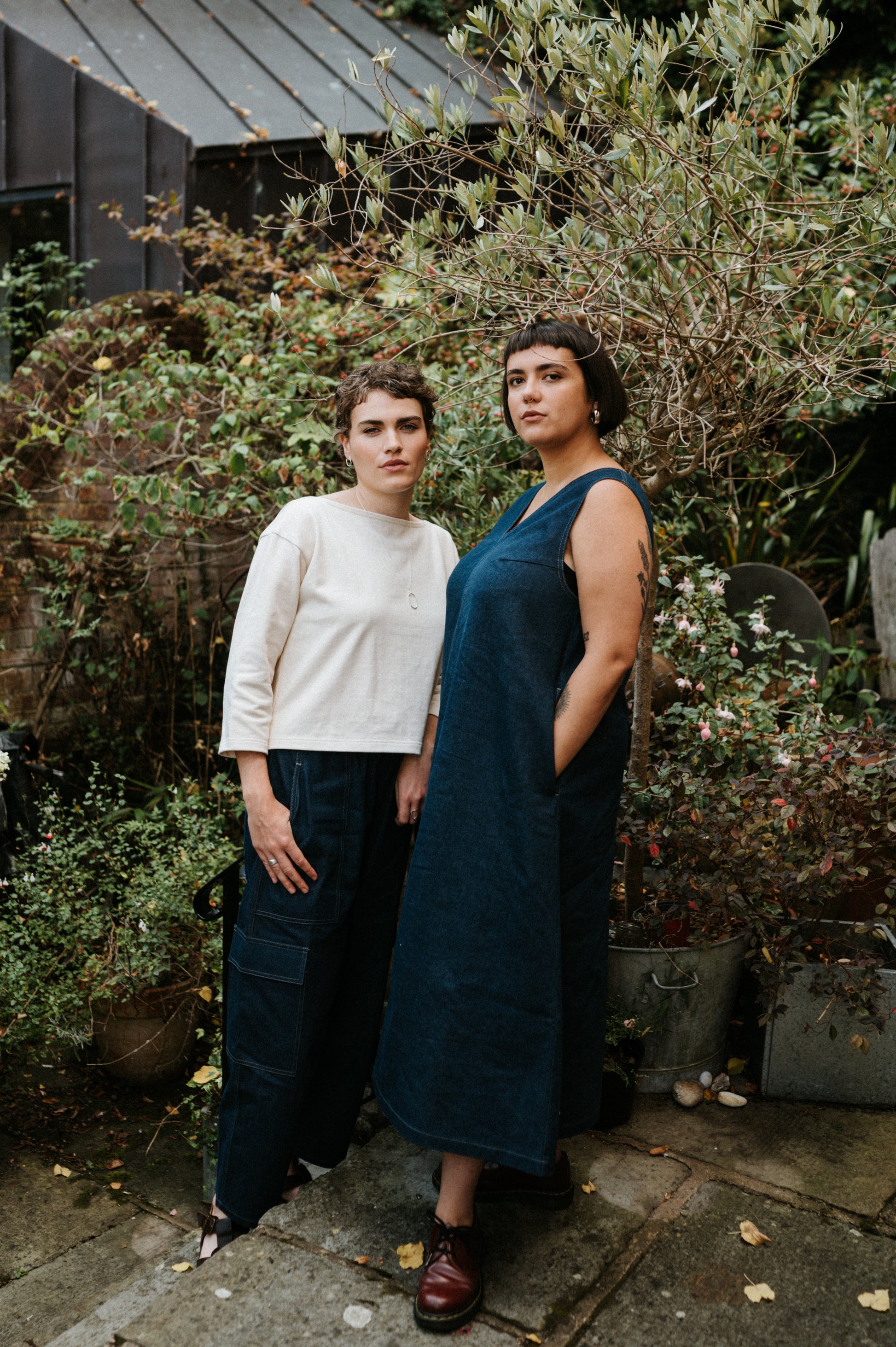 2 women wearing atwin the label outfits standing in a garden