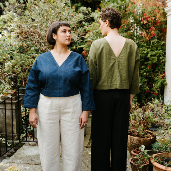 2 women in a garden setting both wearin atwin the label reversible tops