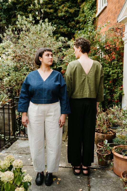 2 women in a garden setting both wearin atwin the label reversible tops