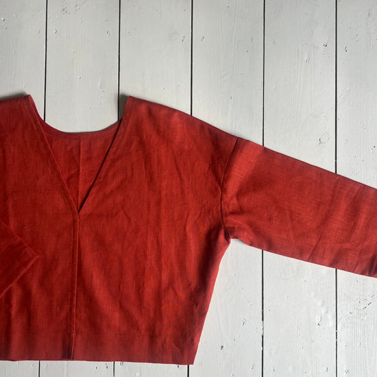 Red blouse on a white wooden floor