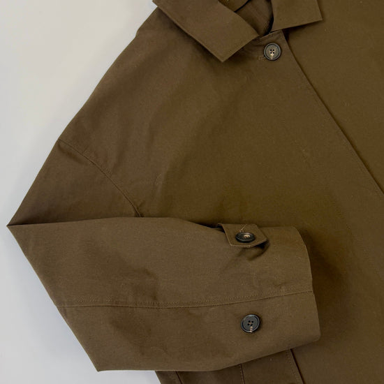 Brown wax rain mac jacket with button details on a white background