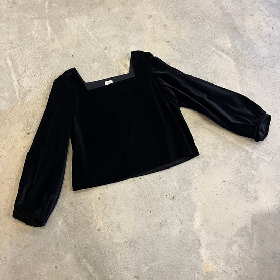 Black velvet top on a grey concrete surface