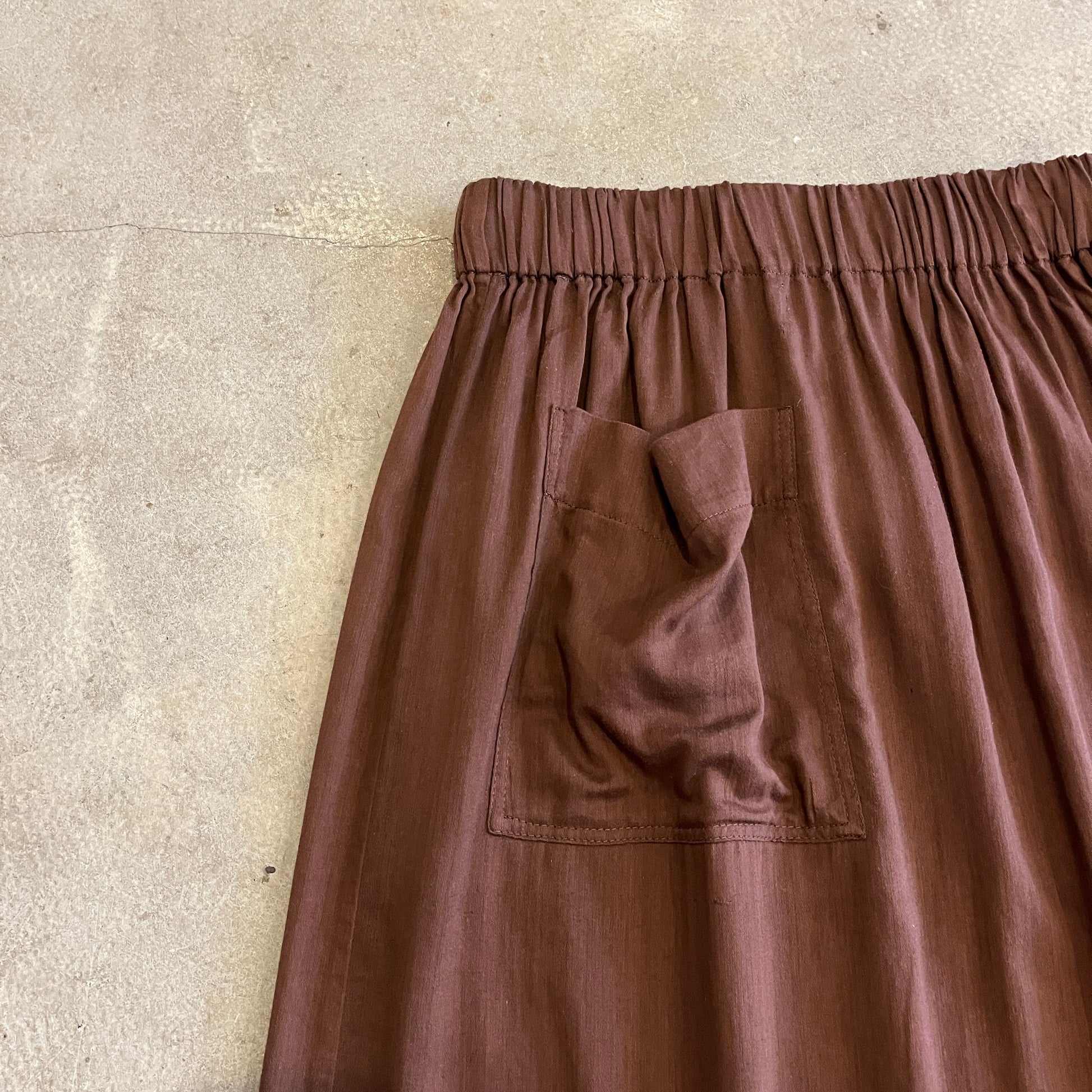 Brown pants with a pocket on a beige background