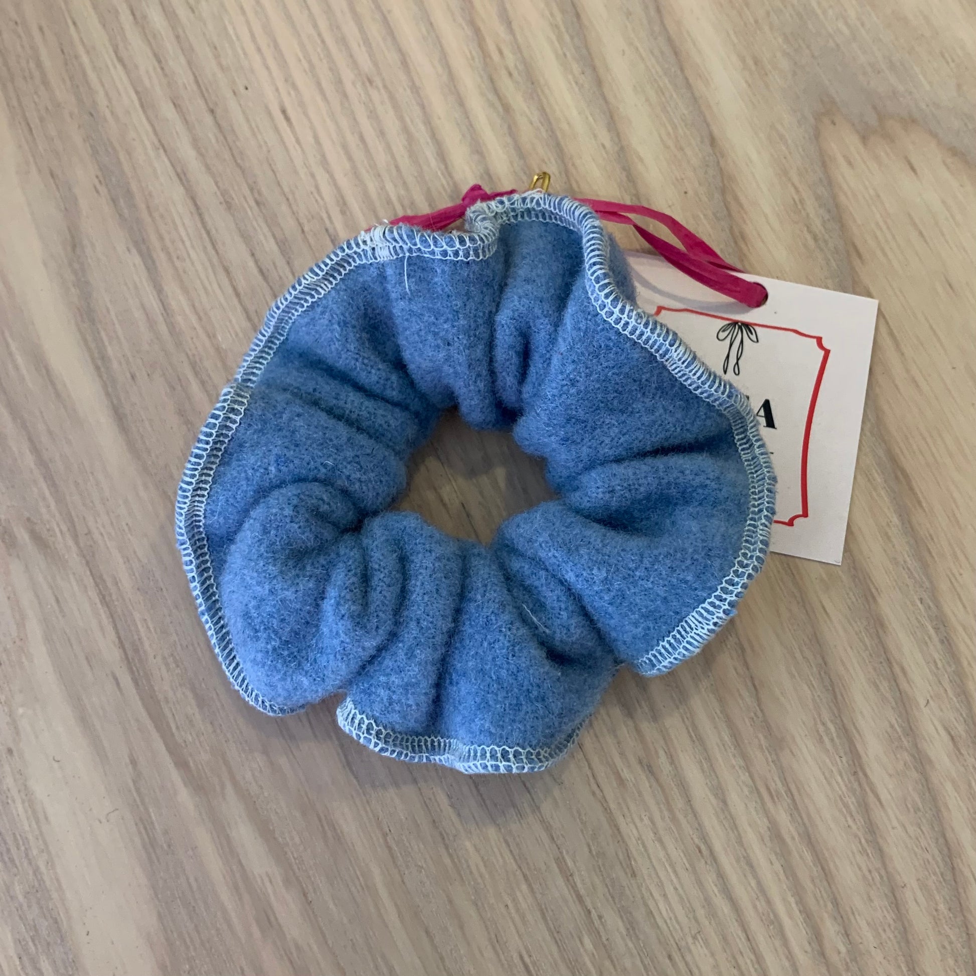 a blue wool scrunchy on a wooden background