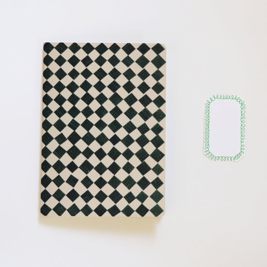 black and white checkered sketchbook on a white background
