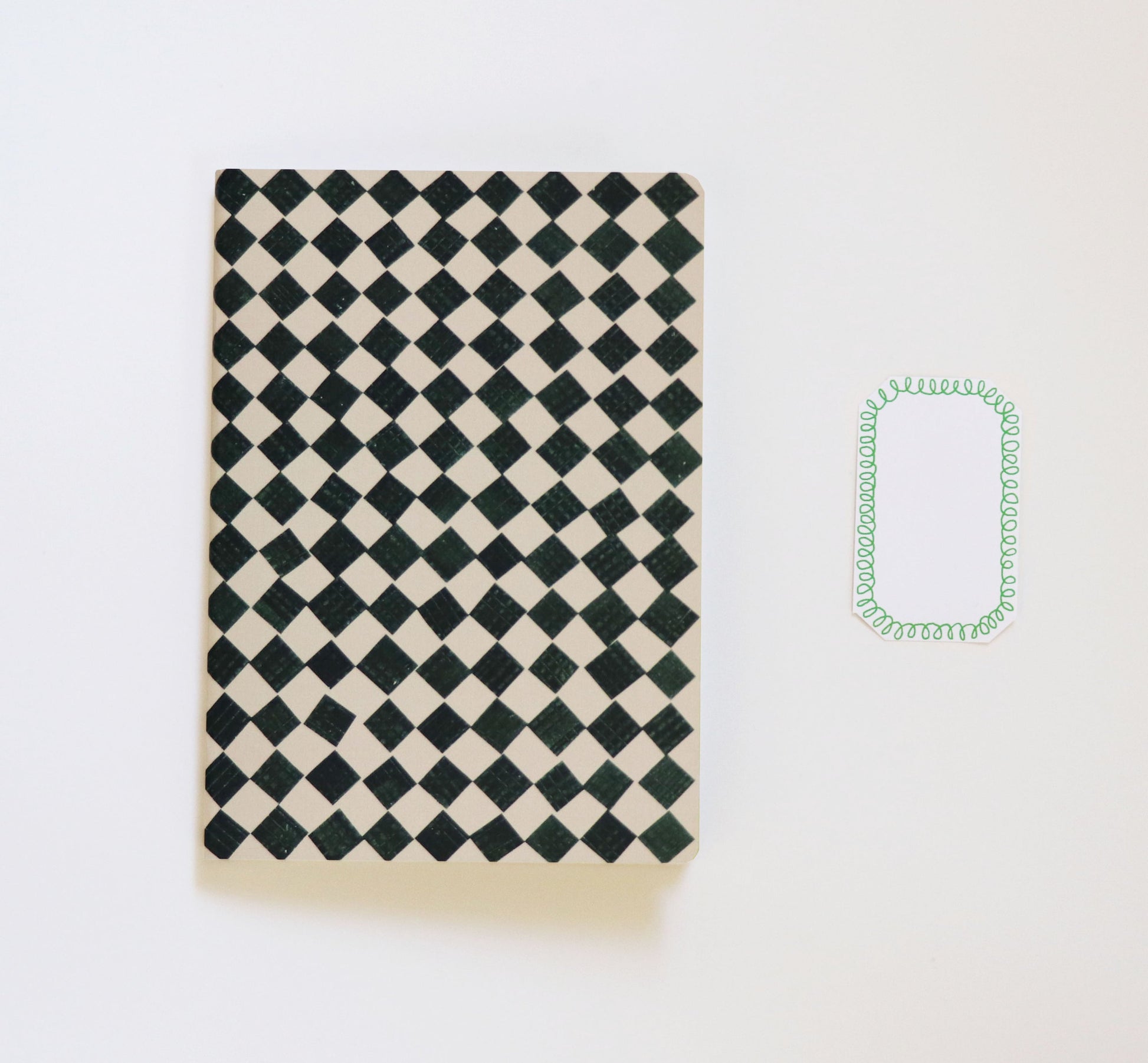 black and white checkered sketchbook on a white background