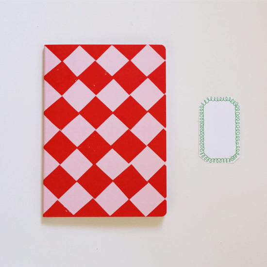 red and pink notebook on a white background