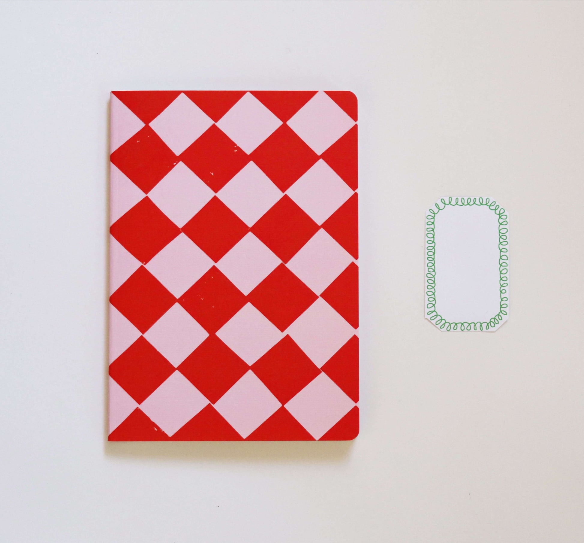red and pink notebook on a white background