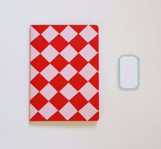 red and pink notebook on a white background