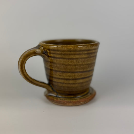 Brown ceramic mug on a white background