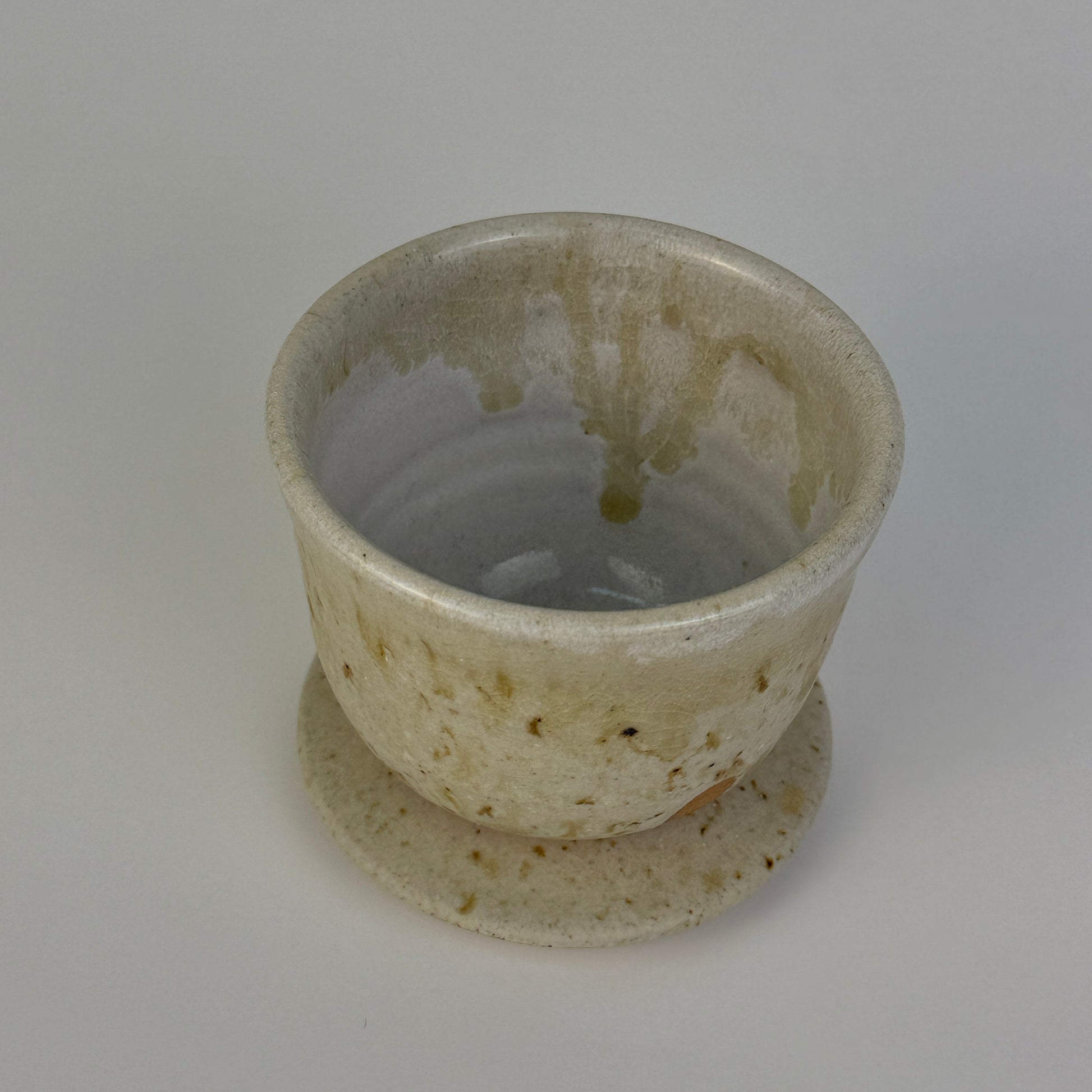 Ceramic cup with a textured surface on a plain background