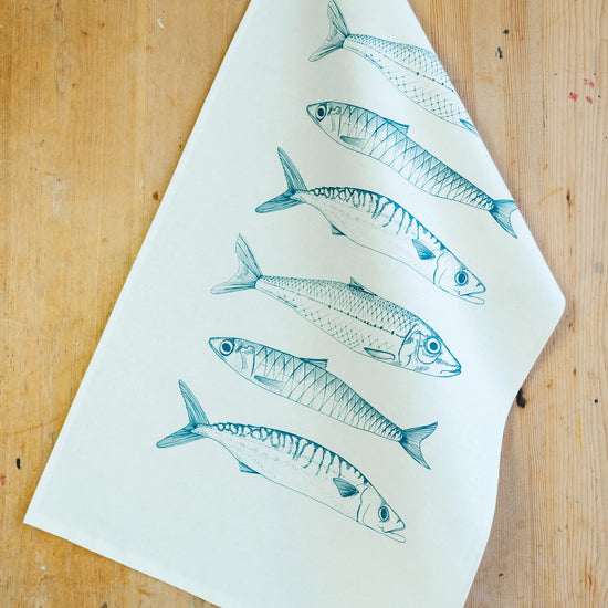 Lottie Day Fish Illustrated Tea Towel On A Wooden Background