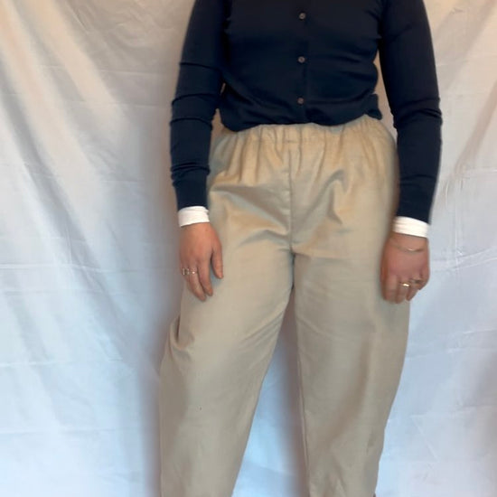 woman wearing a beige pair of trousers