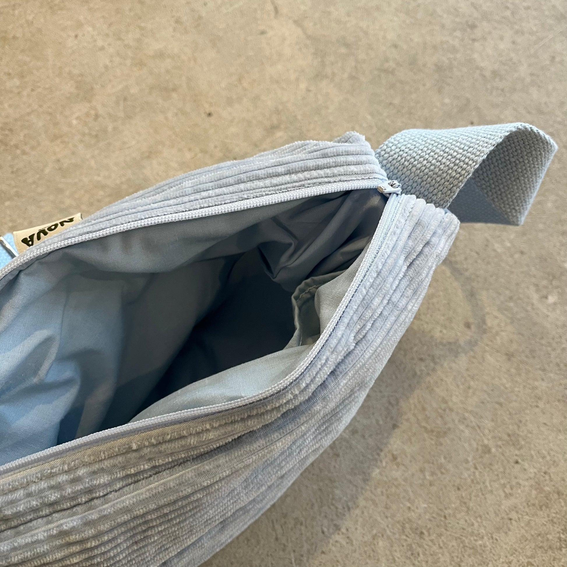 blue bag with a textured surface on a beige background