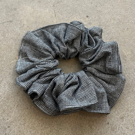 Black and white checkered scrunchie on a beige surface