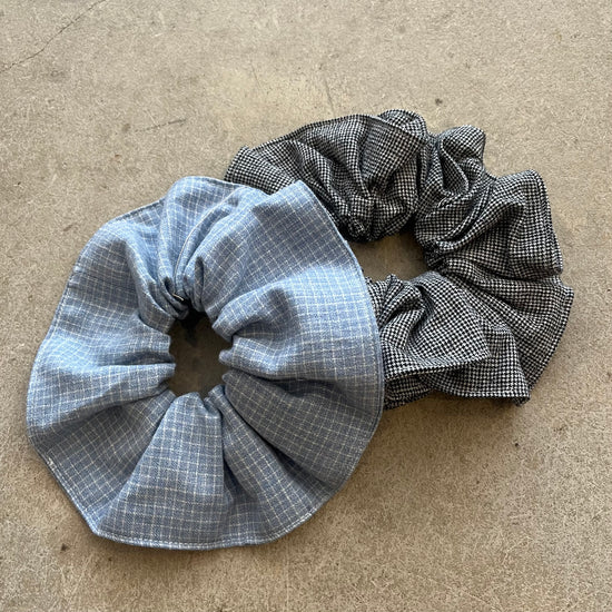 Two checkered scrunchies on a beige surface