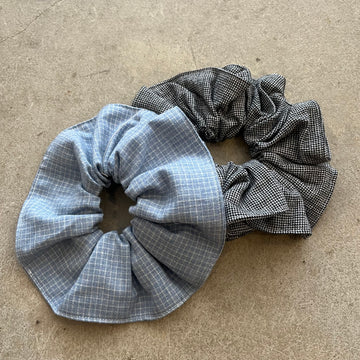 Two checkered scrunchies on a beige surface