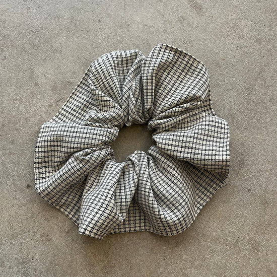 Checkered fabric scrunchie on a gray surface