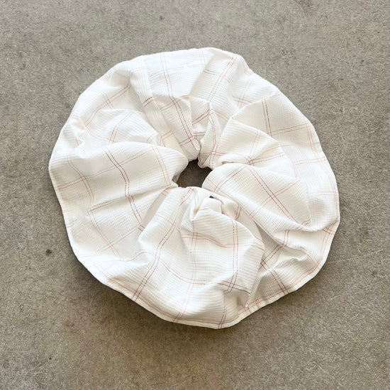 White checkered scrunchie on a gray surface