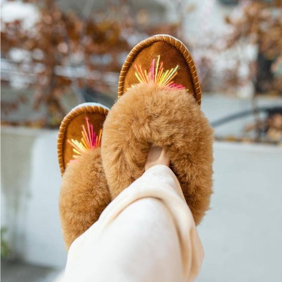 Sheepskin slippers being worn by a woman outdoors