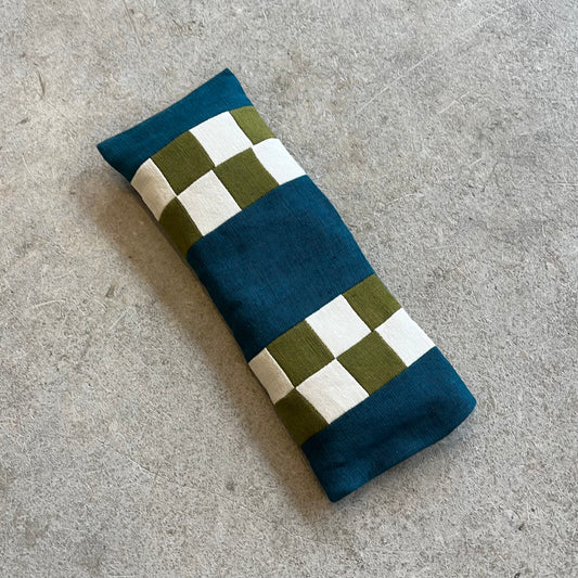 Folded fabric with checkered pattern on a gray surface