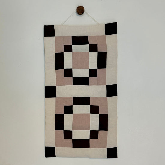 Decorative wall hanging with geometric pattern on a plain background