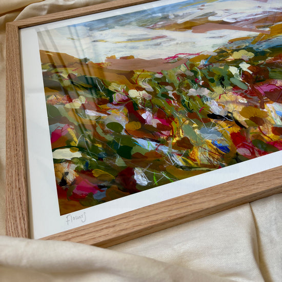 Framed abstract painting on a beige fabric background