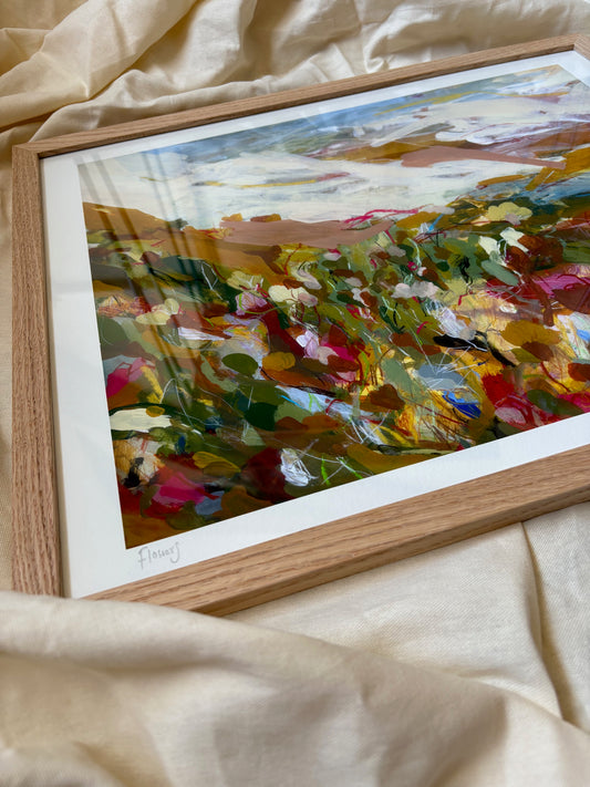 Framed abstract painting on a beige fabric background