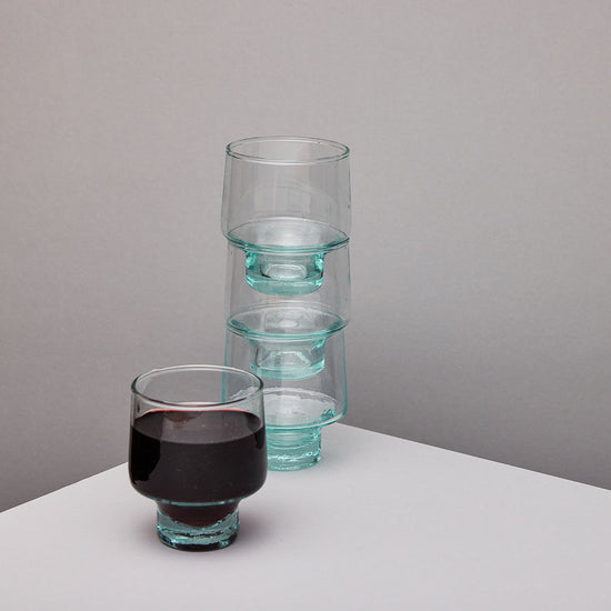 Set of clear glass wine glasses on a grey background