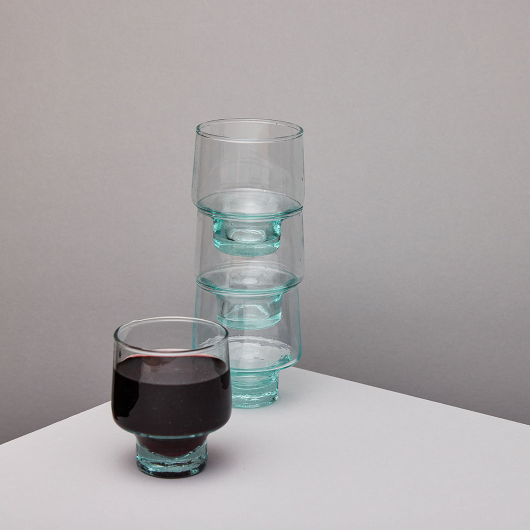 Set of clear glass wine glasses on a grey background