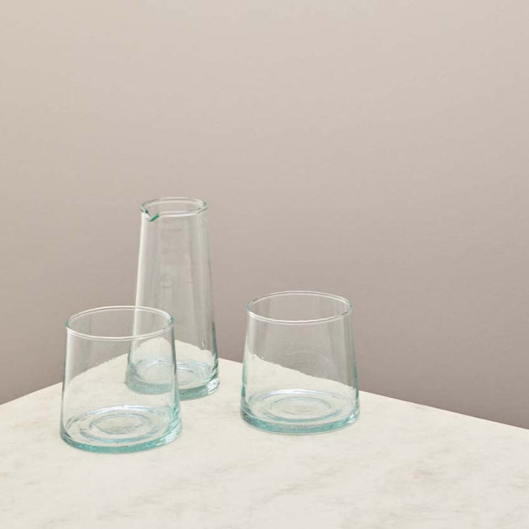 a selection of clear glassware on a taupe background