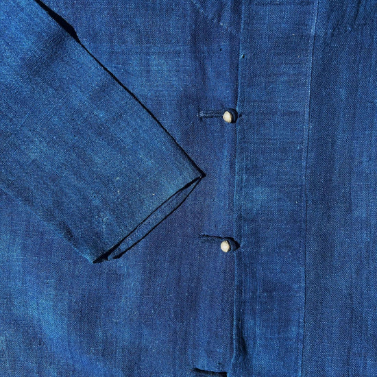 Close up of a blue shirt with metal buttons