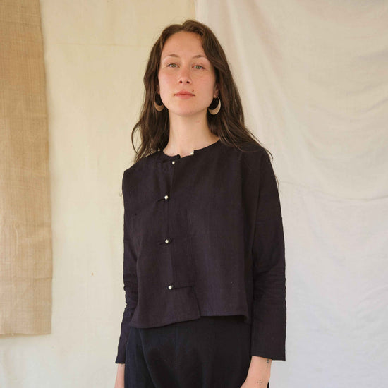 Woman wearing a dark jacket on a white background