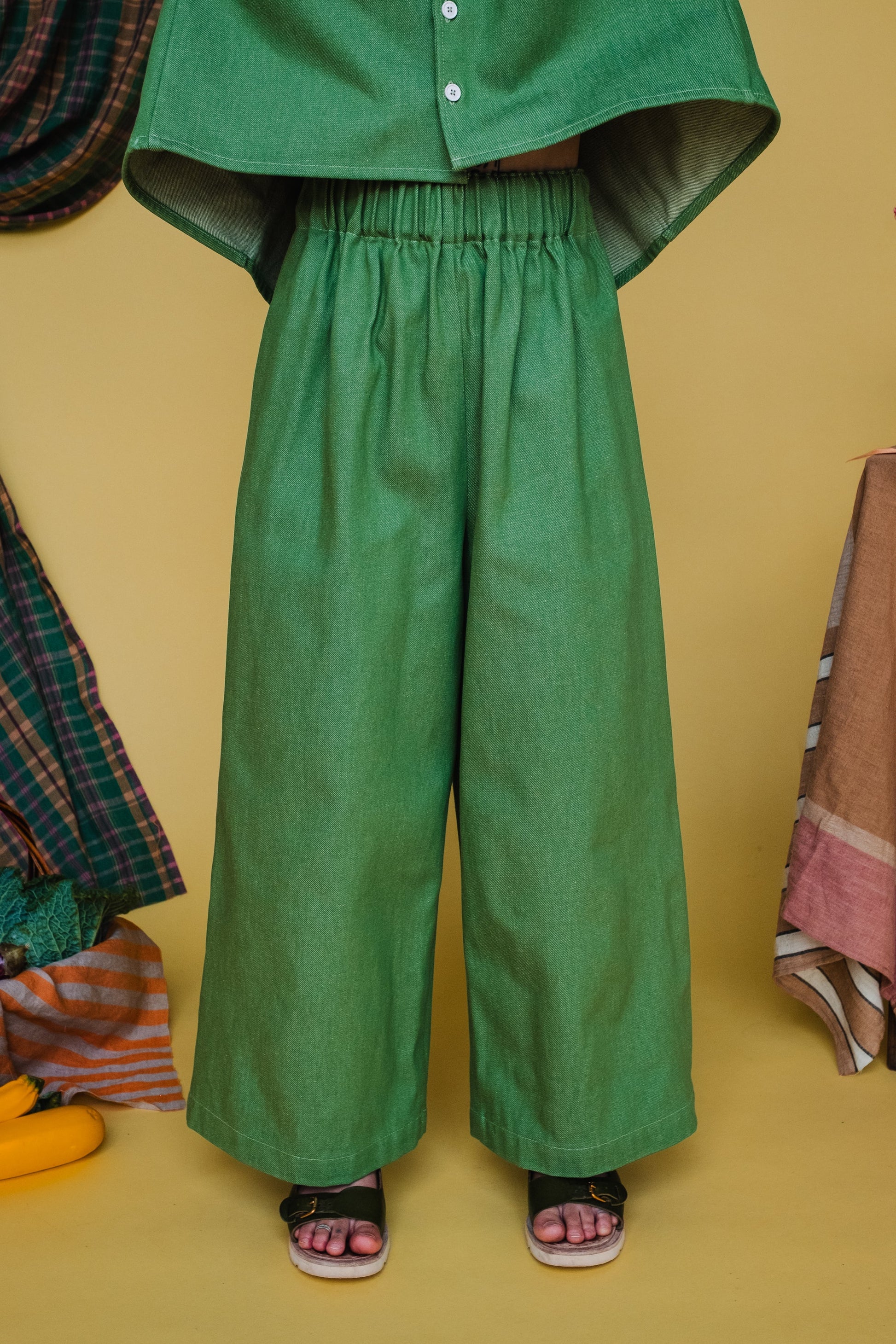woman wearing green wide leg trousers