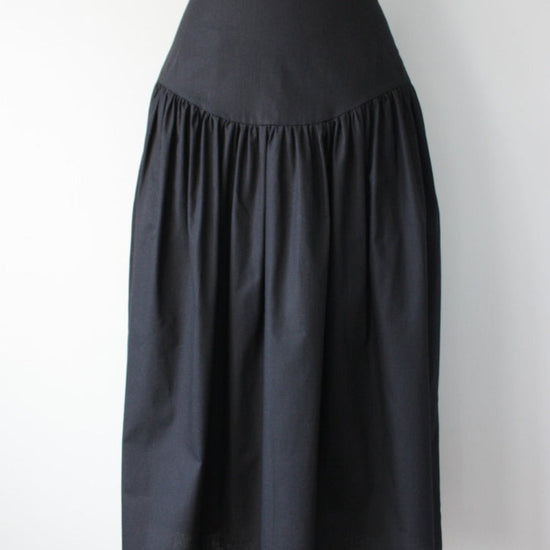 Black skirt on a mannequin against a white background