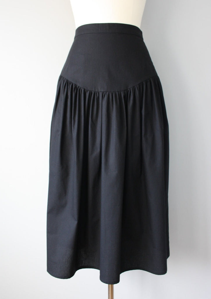 Black skirt on a mannequin against a white background