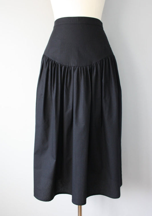 Black skirt on a mannequin against a white background