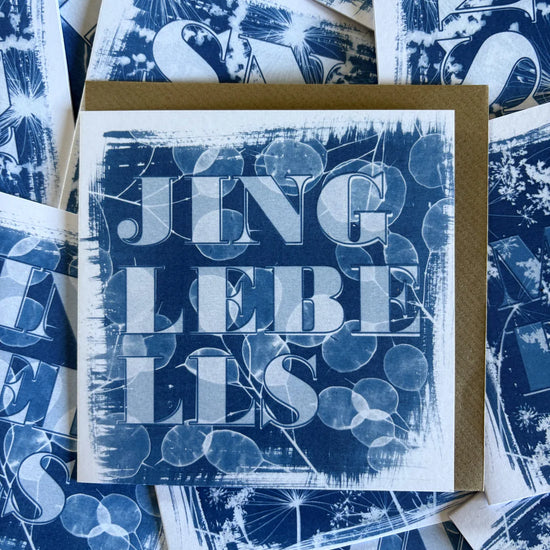 Card with 'jingle bells' text on a blue patterned background