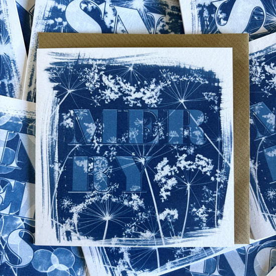 A blue and white card with the word 'merry' typed on