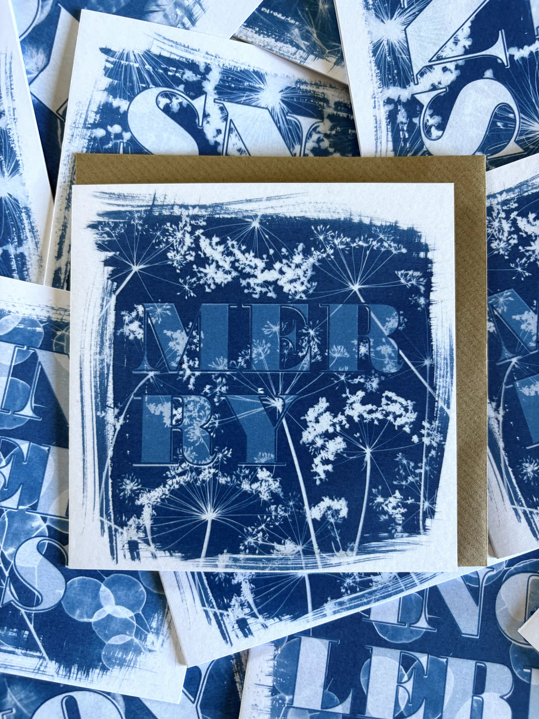 A blue and white card with the word 'merry' typed on