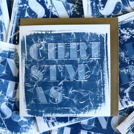 Blue and white card with the word christmas on the front