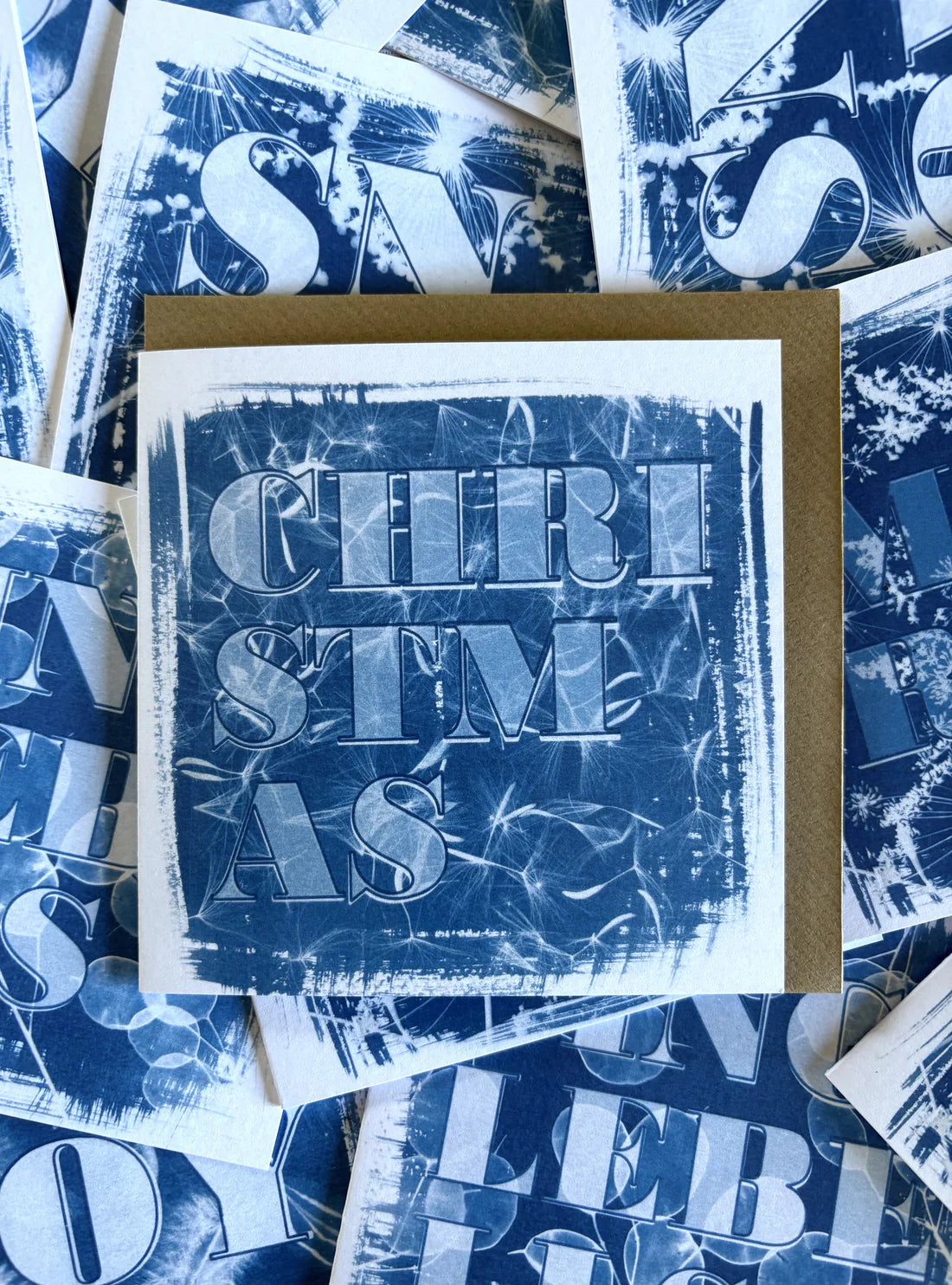 Blue and white card with the word christmas on the front