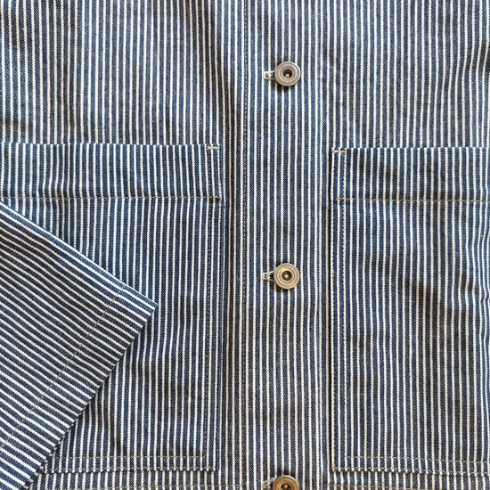 Close-up of a striped shirt with buttons on a wooden surface
