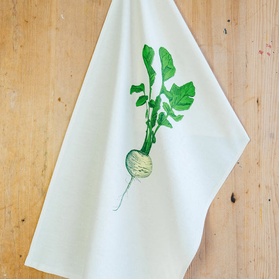 neep illustrated teat towel on a wooden background