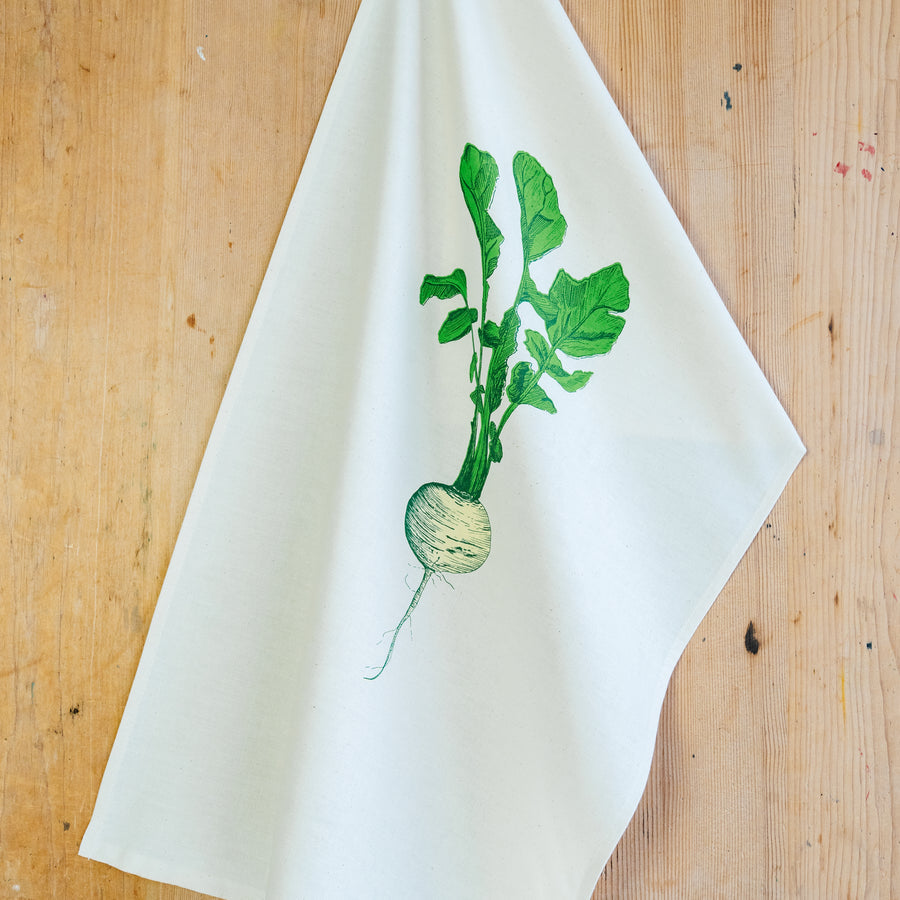 neep illustrated teat towel on a wooden background