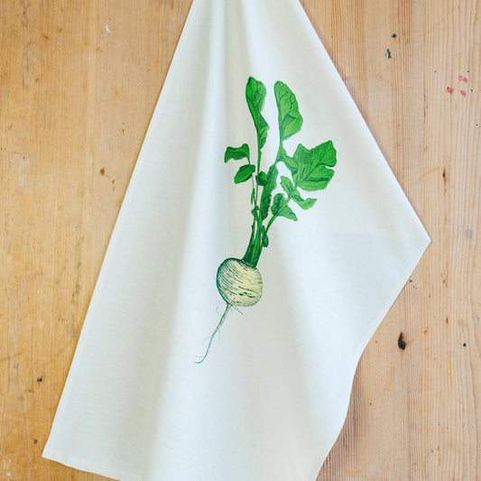 neep illustrated teat towel on a wooden background
