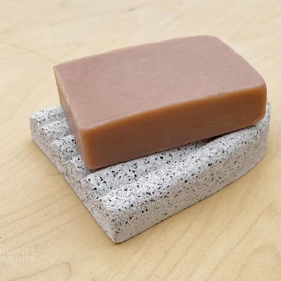 Curved ceramic soap dish with a smooth, minimalist arc design