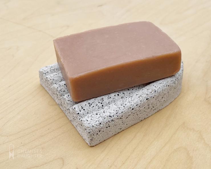 Curved ceramic soap dish with a smooth, minimalist arc design